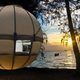 Illustration for article titled This Floating Globe Tent Is a Cocoon for People